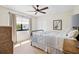 This comfortable bedroom includes hardwood floors, a ceiling fan, and a cozy window seat at 347 Ardenwood Dr, Englewood, FL 34223