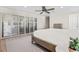 Bedroom features hardwood floors, a ceiling fan, and plantation shutters at 347 Ardenwood Dr, Englewood, FL 34223
