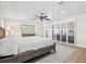 Charming bedroom has hardwood floors, a ceiling fan, and sliding glass doors to the outside at 347 Ardenwood Dr, Englewood, FL 34223
