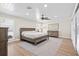 Relaxing bedroom boasts hardwood floors, a ceiling fan, and plenty of natural light at 347 Ardenwood Dr, Englewood, FL 34223