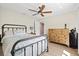 Relaxing bedroom featuring hardwood floors, ceiling fan, and light and airy colors at 347 Ardenwood Dr, Englewood, FL 34223