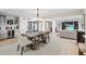 Open-concept dining area connected to a bar and living area, ideal for gatherings at 347 Ardenwood Dr, Englewood, FL 34223