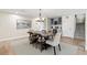 Elegant dining room with a rustic wooden table and a built-in bar area at 347 Ardenwood Dr, Englewood, FL 34223