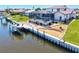 Aerial view of a house with boat dock, lift, and screened-in patio showcasing the waterfront lifestyle at 347 Ardenwood Dr, Englewood, FL 34223