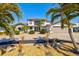 Stunning two-story home with tropical landscaping, paver driveway, and a charming front entrance at 347 Ardenwood Dr, Englewood, FL 34223