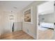 Hallway showcasing wood floors leading to a bedroom, creating a warm and inviting entrance at 347 Ardenwood Dr, Englewood, FL 34223
