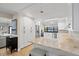 Modern kitchen with white cabinetry, stainless steel appliances, and a breakfast bar at 347 Ardenwood Dr, Englewood, FL 34223