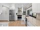 Updated kitchen with stainless steel appliances, white cabinets, and ample counter space at 347 Ardenwood Dr, Englewood, FL 34223