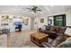 Relax in this spacious living room featuring beamed ceilings, hardwood floors, and a ceiling fan at 347 Ardenwood Dr, Englewood, FL 34223