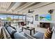 Comfortable screened lanai with beamed ceilings and a view of the pool and canal at 347 Ardenwood Dr, Englewood, FL 34223