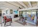 Inviting screened-in patio featuring canal views, beamed ceilings, and comfortable seating at 347 Ardenwood Dr, Englewood, FL 34223