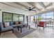 Relaxing outdoor patio with stone floors, beamed ceilings, modern furniture, and canal views at 347 Ardenwood Dr, Englewood, FL 34223