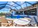 Screened pool with a fire pit and outdoor seating area offering a relaxing outdoor experience at 347 Ardenwood Dr, Englewood, FL 34223