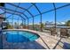 Beautiful pool deck with a screened lanai and comfortable seating with scenic canal views at 347 Ardenwood Dr, Englewood, FL 34223