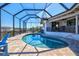 Inviting pool area with screened lanai, brick pavers, and picturesque canal views at 347 Ardenwood Dr, Englewood, FL 34223