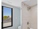 Shower with neutral tilework and updated fixtures enhances this bathroom space at 347 Ardenwood Dr, Englewood, FL 34223