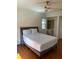 Cozy bedroom featuring hardwood floors, a ceiling fan, and ample natural light at 411 El Greco Dr, Brandon, FL 33511