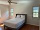 Bedroom with hardwood floors, a bed, and natural light from two windows at 411 El Greco Dr, Brandon, FL 33511