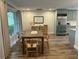 Open-concept dining area featuring wood flooring, stainless steel appliances, and views of backyard at 411 El Greco Dr, Brandon, FL 33511