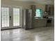 Modern kitchen with stainless steel appliances, gray cabinets, double doors, and wood-look floors at 411 El Greco Dr, Brandon, FL 33511