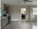 Kitchen featuring gray cabinets, stainless appliances, and open floorplan, with two windows at 411 El Greco Dr, Brandon, FL 33511