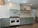 Modern kitchen with white cabinets, stainless steel appliances, and a large island at 411 El Greco Dr, Brandon, FL 33511