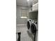 Bright laundry room with grey walls and modern appliances at 411 El Greco Dr, Brandon, FL 33511