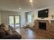 Inviting living room with brick fireplace, hardwood floors, and a comfortable couch at 411 El Greco Dr, Brandon, FL 33511