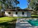 Swimming pool with surrounding patio and partial view of house at 411 El Greco Dr, Brandon, FL 33511