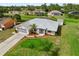 Aerial view highlighting a house with a well-kept lawn, landscaping and a paved driveway at 4268 Mulgrave Ave, North Port, FL 34287