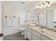 Bathroom with marble countertops, white cabinets, and neutral-colored tile at 4268 Mulgrave Ave, North Port, FL 34287