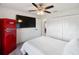 Bedroom with TV, fan and retro fridge at 4268 Mulgrave Ave, North Port, FL 34287