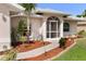 Charming front entrance with well-manicured landscaping and covered entryway at 4268 Mulgrave Ave, North Port, FL 34287