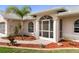Inviting front entrance with elegant architectural details, manicured landscaping, and a well-lit walkway at 4268 Mulgrave Ave, North Port, FL 34287