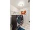 Bright laundry room features new Samsung washer and dryer with storage, and white tile flooring at 4268 Mulgrave Ave, North Port, FL 34287