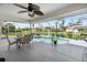 Inviting screened lanai with a kidney-shaped pool and ample seating area, perfect for outdoor entertaining at 4268 Mulgrave Ave, North Port, FL 34287