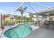 Inviting screened lanai features a kidney-shaped pool, a statue, and several seating areas at 4268 Mulgrave Ave, North Port, FL 34287