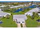 Aerial view of a charming waterfront home with a carport and well-manicured lawn at 4411 Mount Vernon Dr, Bradenton, FL 34210