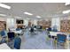 Cozy library space with bookshelves, tables, comfortable seating, and plenty of natural light at 4411 Mount Vernon Dr, Bradenton, FL 34210