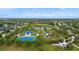 An aerial view of a community park featuring tennis courts, playground, and open green spaces at 4691 Claremont Park Dr, Bradenton, FL 34211