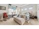 Tranquil bedroom with a daybed, rocking chair, and a view of the lake at 4691 Claremont Park Dr, Bradenton, FL 34211
