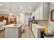 Bright kitchen with white cabinetry, stainless steel appliances, and a convenient island with bar seating at 4691 Claremont Park Dr, Bradenton, FL 34211