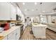 Well-lit kitchen with stainless steel appliances, countertops, and an island with sink and seating at 4691 Claremont Park Dr, Bradenton, FL 34211
