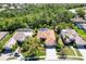 Beautiful aerial view of a single-story home with a screened-in pool and mature landscaping at 4740 Carrington Cir, Sarasota, FL 34243