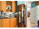 Charming wet bar area with custom cabinetry and glass shelving, adjacent to a home office at 4740 Carrington Cir, Sarasota, FL 34243