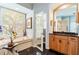 Luxurious bathroom with a marble floor, a soaking tub, and a vanity with granite countertop at 4740 Carrington Cir, Sarasota, FL 34243