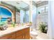 Bathroom featuring a vanity with marble countertop, soaking tub, and contemporary fixtures at 4740 Carrington Cir, Sarasota, FL 34243