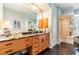 Bright bathroom with a black marble floor, a wood vanity, and a separate walk-in shower at 4740 Carrington Cir, Sarasota, FL 34243