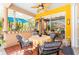 Outdoor lanai with comfortable seating, tile floors, and access to the enclosed pool area and dining area at 4740 Carrington Cir, Sarasota, FL 34243