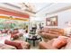 Cozy living room with comfortable seating and view of a screened pool area at 4740 Carrington Cir, Sarasota, FL 34243